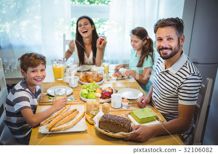 Happy family having breakfast together Happy family having breakfast together 32106082