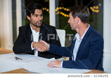 Businessmen shaking hands with each other Businessmen shaking hands with each other 32106293