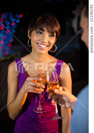 Couple toasting glass of champagne in bar 32106295