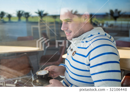 Smiling man holding a coffee cup 32106448