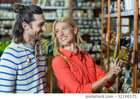 Happy couple selecting pickles 32106575