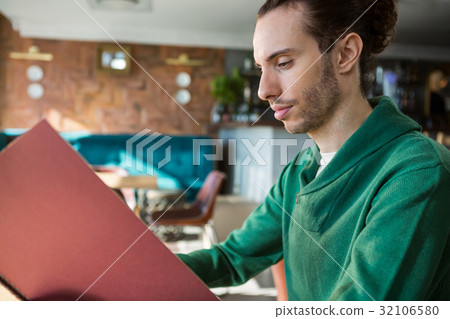 Man looking at menu Man looking at menu 32106580