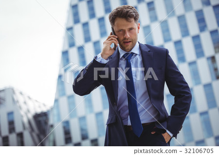 Businessman talking on mobile phone 32106705