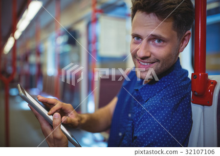 Portrait of handsome man using digital tablet in train Portrait of handsome man using digital tablet in train 32107106