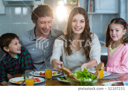 Happy family having breakfast Happy family having breakfast 32107231