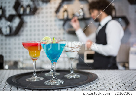 Various cocktails on a serving tray in bar counter Various cocktails on a serving tray in bar counter 32107303