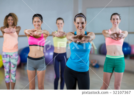 Group of fitness team performing stretching exercise Group of fitness team performing stretching exercise 32107367