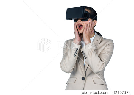 Businesswoman using virtual reality headset Businesswoman using virtual reality headset 32107374