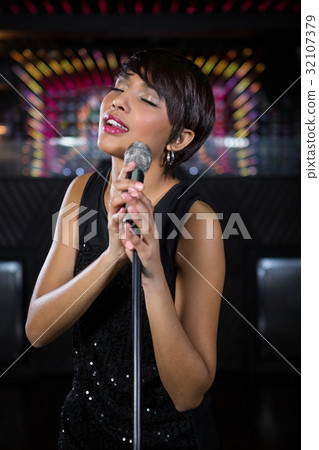 Woman singing in bar Woman singing in bar 32107379