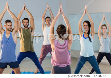 Instructor taking yoga class Instructor taking yoga class 32107638