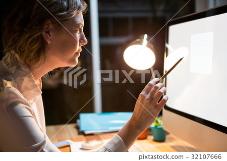 Businesswoman working on computer at her desk 32107666