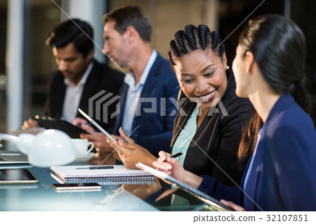 Businesswoman interacting with a colleague Businesswoman interacting with a colleague 32107851