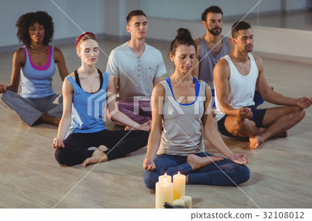 Group of people performing yoga 32108012