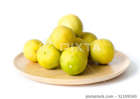 Fresh lime on wooden plate isolated on white Fresh lime on wooden plate isolated on white 32109160