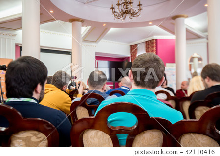 Back view of press-conference audience 32110416