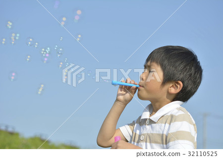 Boys playing with soap bubbles Boys playing with soap bubbles 32110525