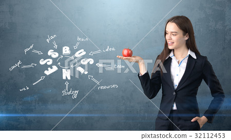 Beauty girl in a suit standing near wall with a Beauty girl in a suit standing near wall with a 32112453