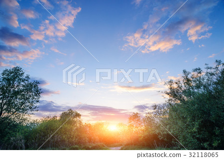 Beautiful sunset above rural lane.  32118065