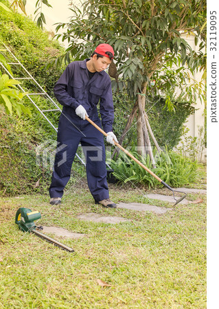 Gardener with garden tools at work Gardener with garden tools at work 32119095