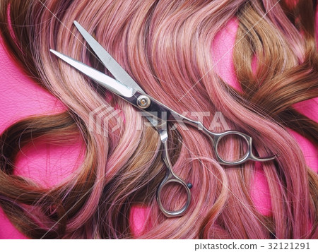 Hair cutting shears on pink background 32121291