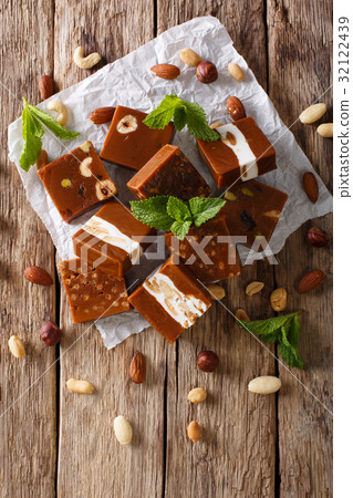 Caramelized toffee with various nuts close-up Caramelized toffee with various nuts close-up 32122439