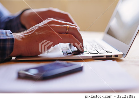 Close-up of a worker using a laptop computer Close-up of a worker using a laptop computer 32122882