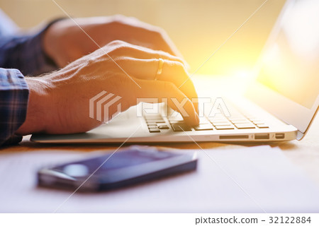 Close-up of a worker using a laptop computer Close-up of a worker using a laptop computer 32122884