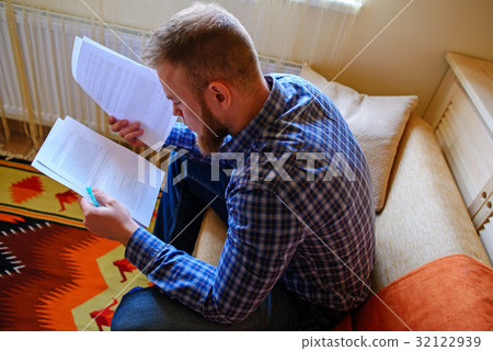 Young handsome man sitting on the couch Young handsome man sitting on the couch 32122939