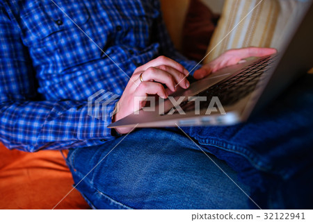 Young man working absorbed on laptop at home Young man working absorbed on laptop at home 32122941
