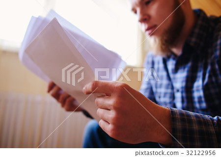 Young handsome man sitting on the couch Young handsome man sitting on the couch 32122956