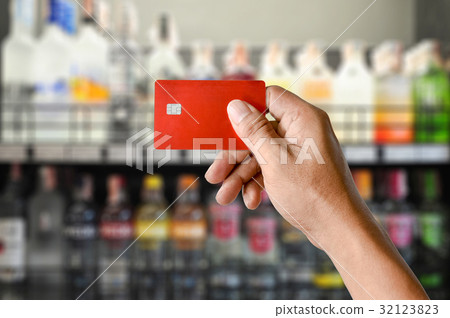 hand holding credit card on Wine Supermarket store hand holding credit card on Wine Supermarket store 32123823
