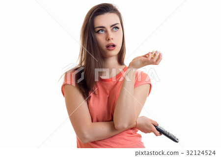 young beautiful thoughtful girl keeps the remote young beautiful thoughtful girl keeps the remote 32124524