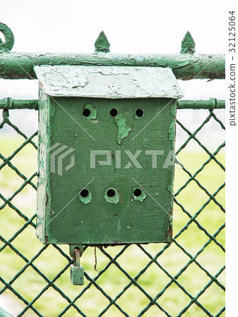Old metallic mailbox on the fence 32125064