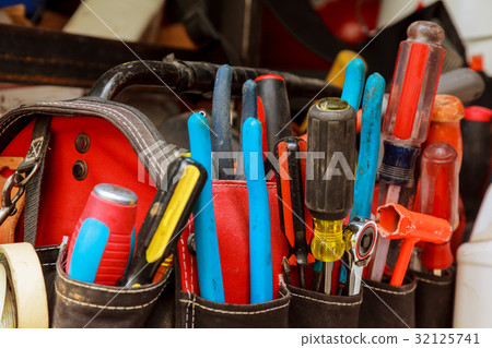 Work tools in bag on wood background. Work tools in bag on wood background. 32125741