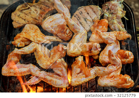 Chicken wings on barbecue grill with fire Chicken wings on barbecue grill with fire 32125779
