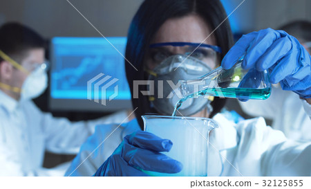 Woman in laboratory working with chemicals 32125855