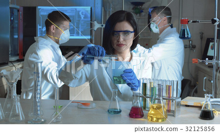 Woman in laboratory working with chemicals 32125856