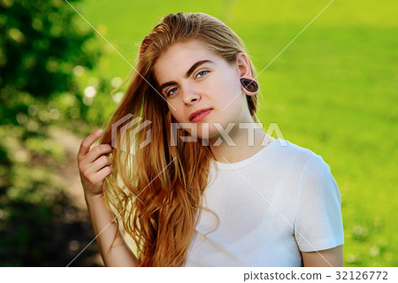 beautiful woman with wooden tunnels in her ears beautiful woman with wooden tunnels in her ears 32126772