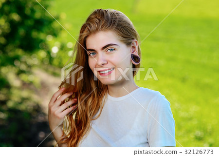 beautiful woman with wooden tunnels in her ears beautiful woman with wooden tunnels in her ears 32126773