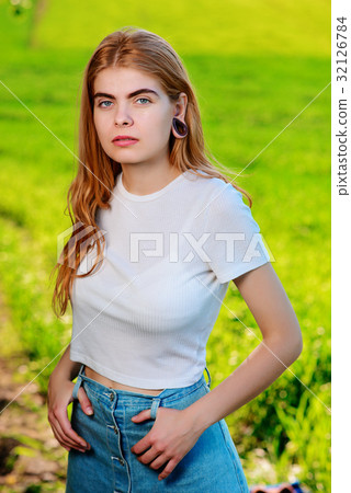 beautiful woman with wooden tunnels in her ears beautiful woman with wooden tunnels in her ears 32126784