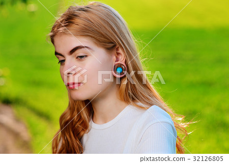 beautiful woman with wooden tunnels in her ears beautiful woman with wooden tunnels in her ears 32126805