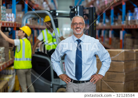 Warehouse manager standing with hands on hips 32128584