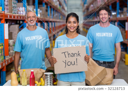 Happy colleagues holding sign boards with thank you message Happy colleagues holding sign boards with thank you message 32128713