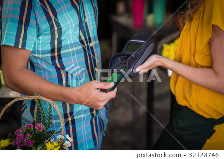 Man making payment with his credit card Man making payment with his credit card 32128746