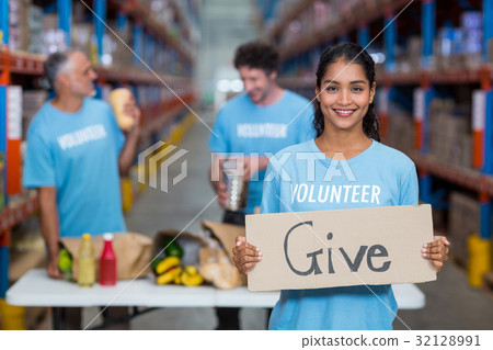 Portrait of happy volunteer holding sign boards with message Portrait of happy volunteer holding sign boards with message 32128991