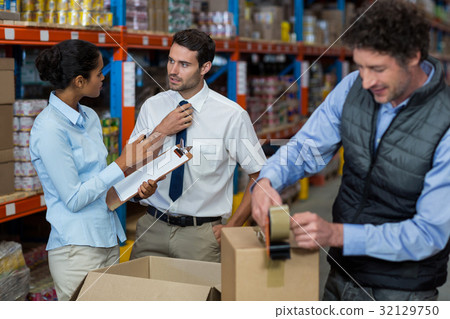 Warehouse workers preparing a shipment Warehouse workers preparing a shipment 32129750