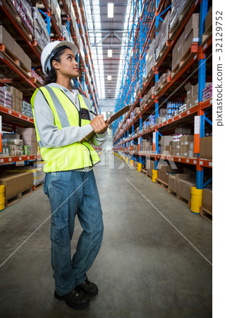 Female warehouse worker looking at packages Female warehouse worker looking at packages 32129752