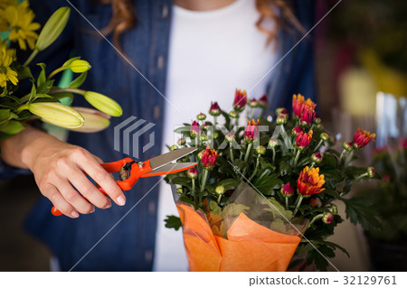 Female florist preparing flower bouquet Female florist preparing flower bouquet 32129761