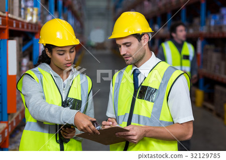 Warehouse workers interacting with each other Warehouse workers interacting with each other 32129785