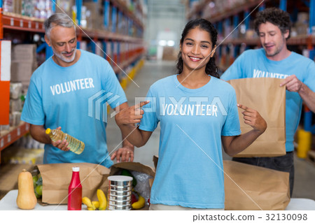 Portrait of volunteer pointing at t-shirt Portrait of volunteer pointing at t-shirt 32130098